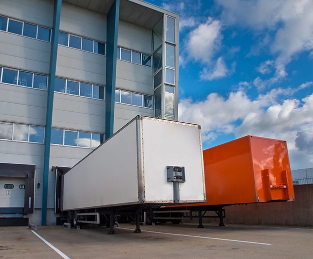 Two trucks in front of a repair center