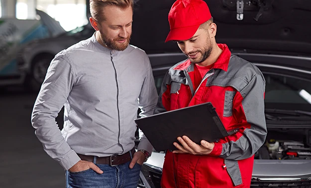 Victory Truck Shop mechanic explaining the work process to a client